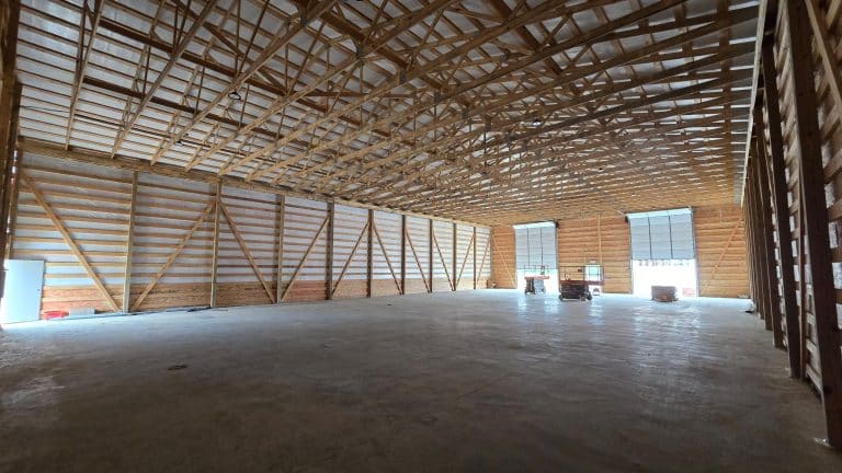 Spacious interior of wooden warehouse structure.
